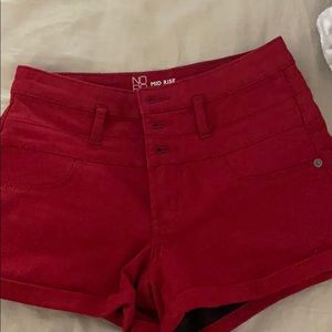Mid rise red shorts begging
